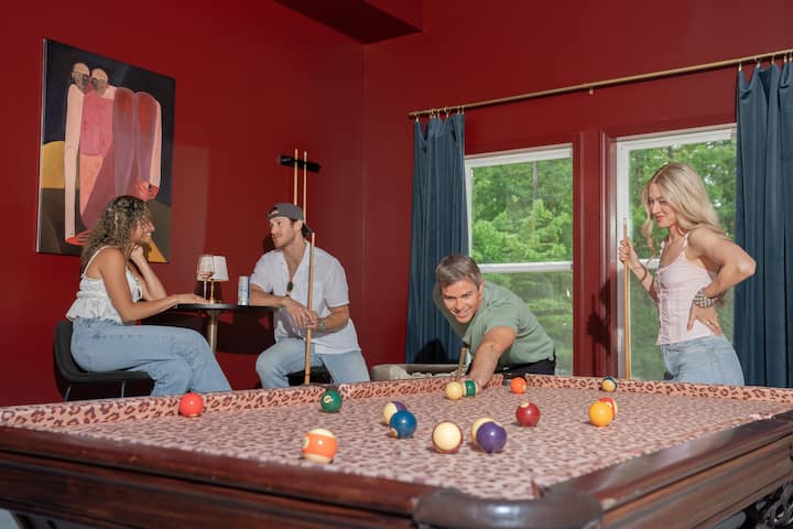 Friends playing pool in the game room