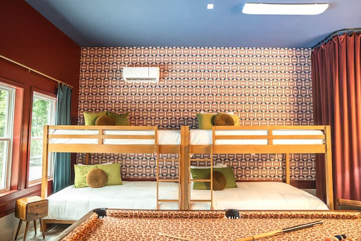 Two queen-over-queen bunks in the game room